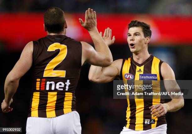 Jaeger O'Meara of the Hawks congratulates Jarryd Roughead of the Hawks on a goal during the 2018 AFL round 16 match between the Western Bulldogs and...