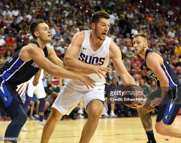 Alec Peters of the Phoenix Suns controls the ball against Kyle Collinsworth and Mitchell Creek of the Dallas Mavericks during the 2018 NBA Summer...