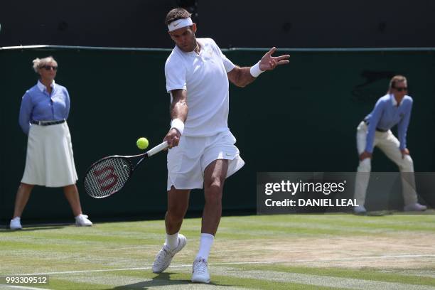 Argentina's Juan Martin del Potro returns to France's Benoit Paire in their men's singles third round match on the sixth day of the 2018 Wimbledon...