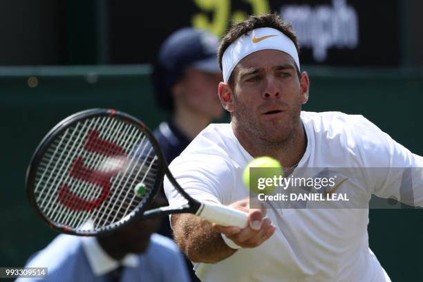 Argentina's Juan Martin del Potro returns to France's Benoit Paire in their men's singles third round match on the sixth day of the 2018 Wimbledon...