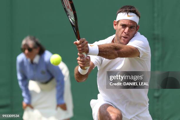 Argentina's Juan Martin del Potro returns to France's Benoit Paire in their men's singles third round match on the sixth day of the 2018 Wimbledon...