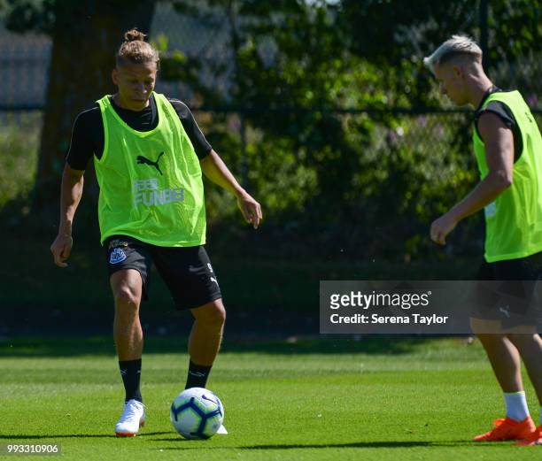 Dwight Gayle receives the ball from Matt Ritchie during the Newcastle United Training Session at the Newcastle United Training Centre on July 7 in...