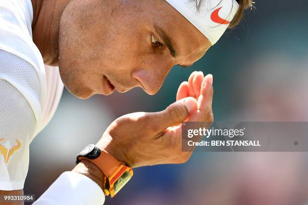 Spain's Rafael Nadal reacts against Australia's Alex De Minaur during their men's singles third round match on the sixth day of the 2018 Wimbledon...