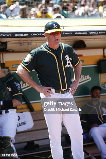 Third Base Coach Matt Williams of the Oakland Athletics stands in the dugout during the game against the Kansas City Royals at the Oakland Alameda...