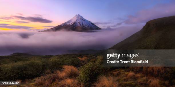 fog around mount taranaki in new zealand. - dormant volcano stock pictures, royalty-free photos & images