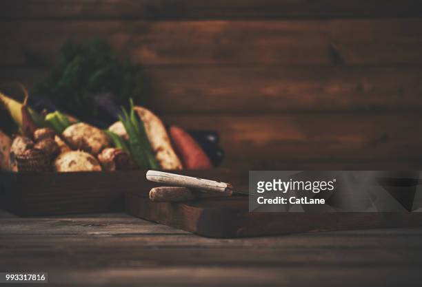 still life of a crate of assorted vegetables shot in dark moody light - jicama stock pictures, royalty-free photos & images
