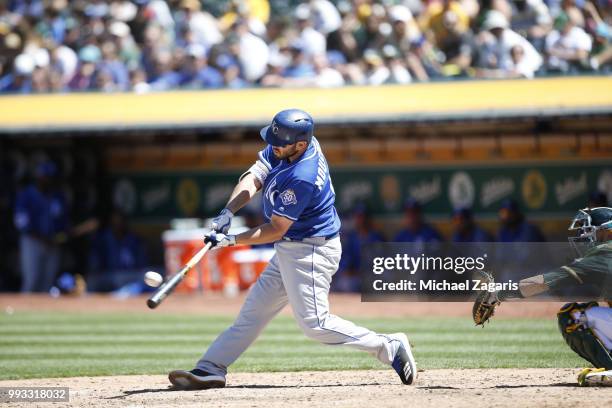 Mike Moustakas of the Kansas City Royals bats during the game against the Oakland Athletics at the Oakland Alameda Coliseum on June 10, 2018 in...