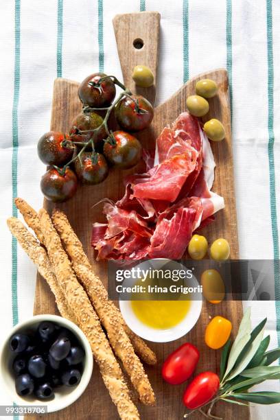 prosciutto crudo. meat and multicolored tomatoes, - crudo imagens e fotografias de stock