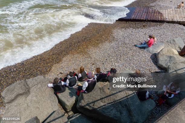 Some of the Morris Dancing sides take a break on the beach at the 25th Sheringham Potty Festival with a parade and dance through the streets of the...