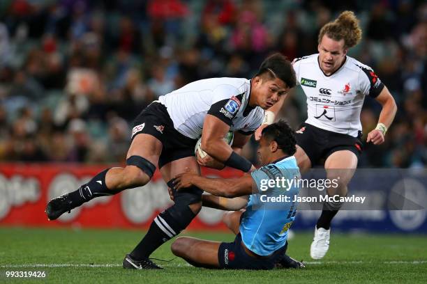 Kazuki Himeno of the Sunwolves is tacked by Kurtley Beale of the Waratahs during the round 18 Super Rugby match between the Waratahs and the...