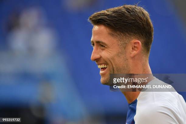 England's defender Gary Cahill laughs during the warm-up before the Russia 2018 World Cup quarter-final football match between Sweden and England at...
