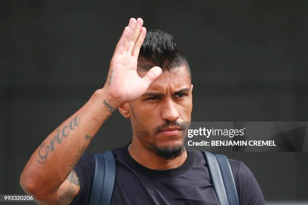 Brazil's midfielder Paulinho waves as he leaves his team's hotel in Kazan on July 7 a day after the five-time champions crashed out of the Russia...