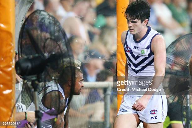 Andrew Brayshaw of the Dockers cools down ner the fan during the round 16 AFL match between the Melbourne Demons and the Fremantle Dockers at TIO...