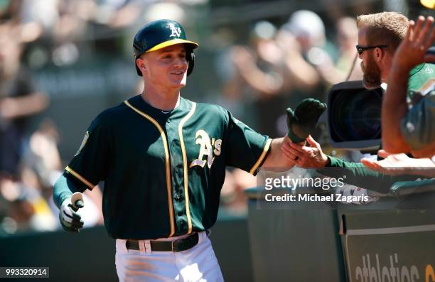 Matt Chapman of the Oakland Athletics is congratulated at the dugout after hitting a home run during the game against the Kansas City Royals at the...