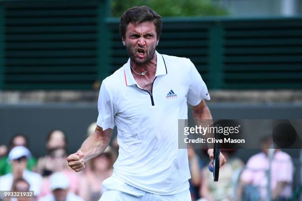 Gilles Simon of France celebrates winning match point against Matthew Ebden of Australia during their Men's Singles third round match on day six of...