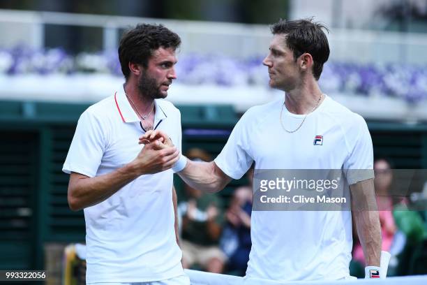 Gilles Simon of France and Matthew Ebden of Australia embrace at the net during their Men's Singles third round match on day six of the Wimbledon...