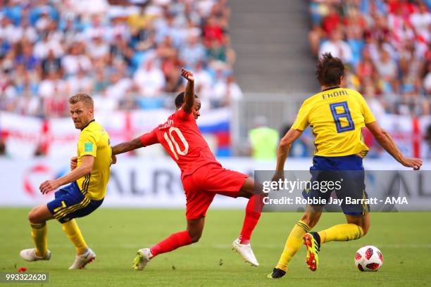 Raheem Sterling of England competes with Albin Ekdal and Sebastian Larsson of Sweden during the 2018 FIFA World Cup Russia Quarter Final match...