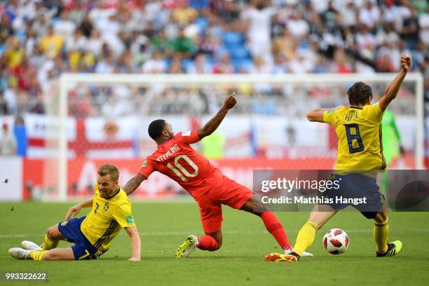 Raheem Sterling of England tackles Albin Ekdal of Sweden during the 2018 FIFA World Cup Russia Quarter Final match between Sweden and England at...