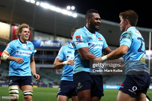Ned Hanigan and Taqele Naiyaravoro of the Waratahs congratulate Bryce Hegarty as he celebrates scoring a try during the round 18 Super Rugby match...
