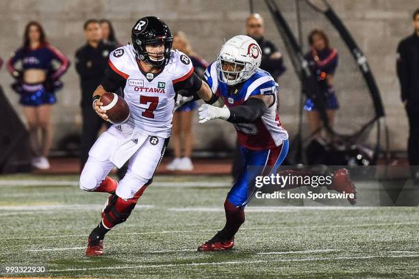 Montreal Alouettes Defensive Linesman Jamaal Westerman chases Ottawa RedBlacks Quarterback Trevor Harris trying to sack him during the Ottawa...