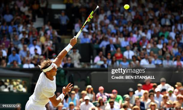 Spain's Rafael Nadal serves against Australia's Alex De Minaur during their men's singles third round match on the sixth day of the 2018 Wimbledon...