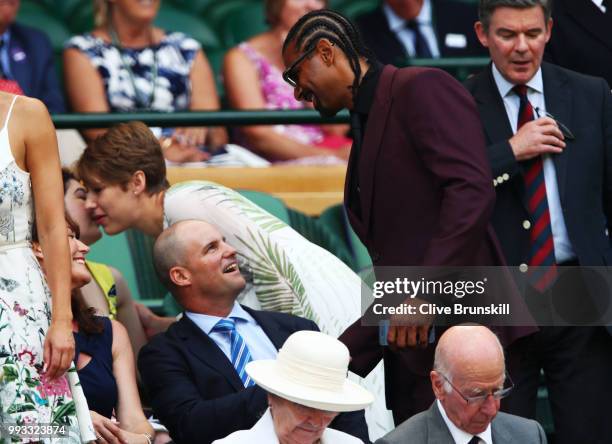 Former cricketer Andrew Strauss greets boxer David Haye as they attend day six of the Wimbledon Lawn Tennis Championships at All England Lawn Tennis...