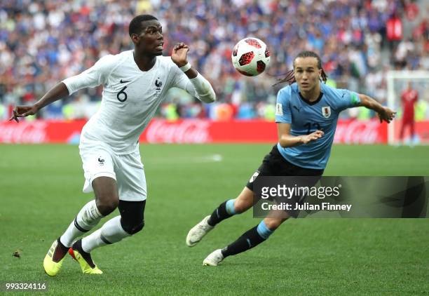 Paul Pogba of France battles with Diego Laxalt of Uruguay during the 2018 FIFA World Cup Russia Quarter Final match between Winner Game 49 and Winner...