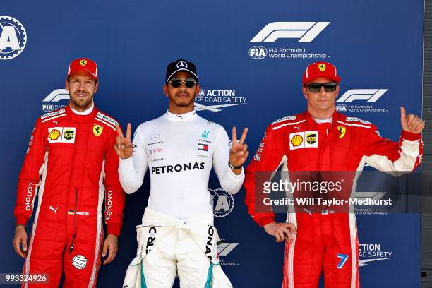 Top three qualifiers Lewis Hamilton of Great Britain and Mercedes GP, Sebastian Vettel of Germany and Ferrari, and Kimi Raikkonen of Finland and...