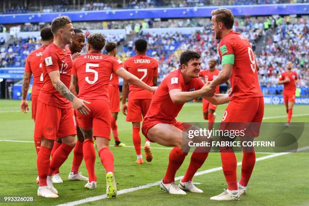 England's defender Harry Maguire celebrates with England's forward Harry Kane after scoring the opener during the Russia 2018 World Cup quarter-final...