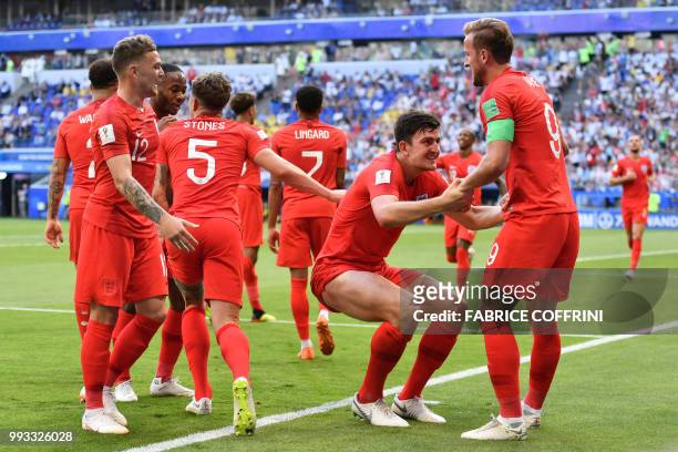 England's defender Harry Maguire celebrates with England's forward Harry Kane after scoring the opener during the Russia 2018 World Cup quarter-final...