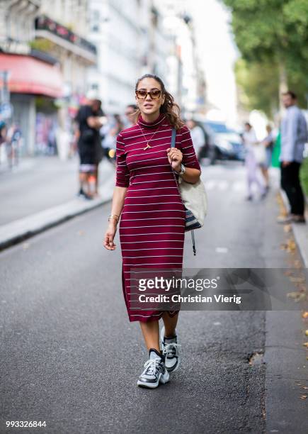 Tamara Kalinic wearing striped dress, Chanel backpack is seen outside Viktor & Rolf on day four during Paris Fashion Week Haute Couture FW18 on July...