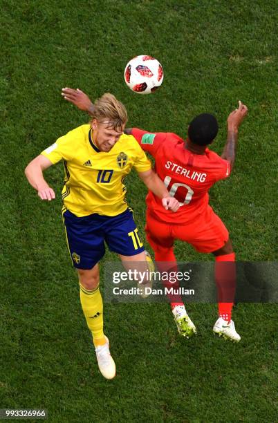 Emil Forsberg of Sweden wins a header over Raheem Sterling of England during the 2018 FIFA World Cup Russia Quarter Final match between Sweden and...