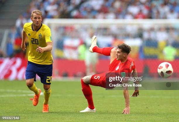 Ola Toivonen of Sweden and John Stones of England compete for the ball during the 2018 FIFA World Cup Russia Quarter Final match between Sweden and...