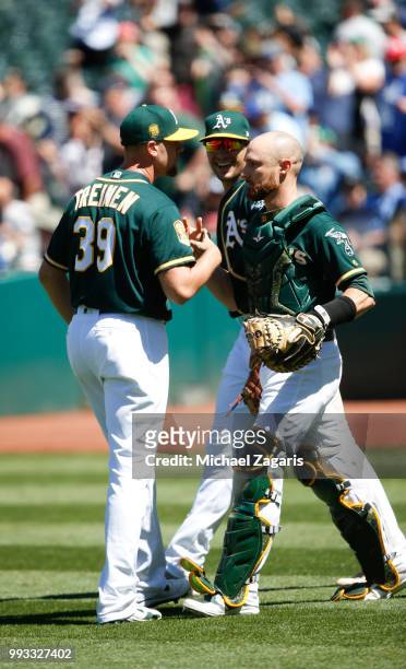 Blake Treinen and Jonathan Lucroy of the Oakland Athletics celebrate on the field following the game against the Kansas City Royals at the Oakland...