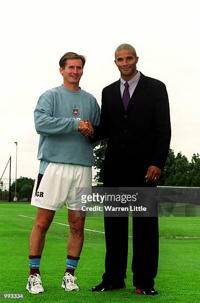 David James shakes hands with his new manager Glenn Roeder during a press conference at West Hams training ground in Chadwell Heath, to announce his...