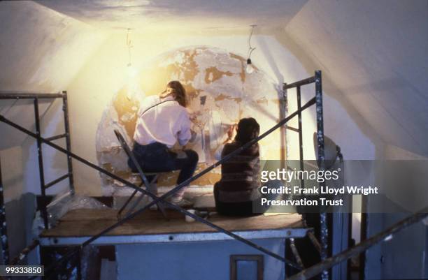 Artists restoring the Orlando Giannini murals of Native American figures in the master bedroom, at the Frank Lloyd Wright Home and Studio, located at...