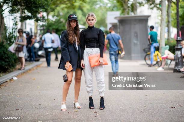 Erika Boldrin wearing Diesel cap Hate Couture, mini Louis Vuitton bag and Caroline Daur wearing orange Prada clutch, black turtleneck, Prada heels,...