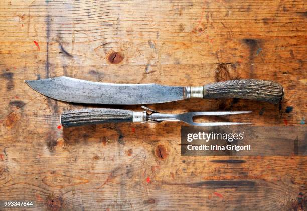 carving set for meat on the old wooden background - carving set stock pictures, royalty-free photos & images