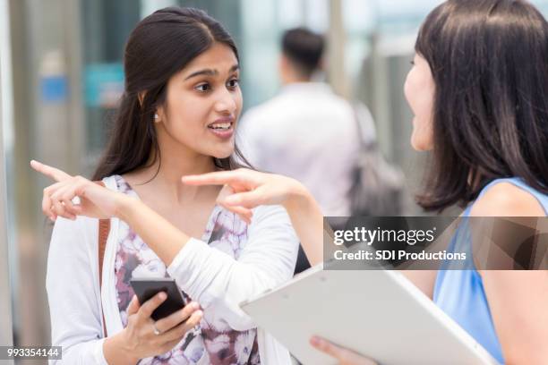 young woman asking for directions - tourist asking stock pictures, royalty-free photos & images