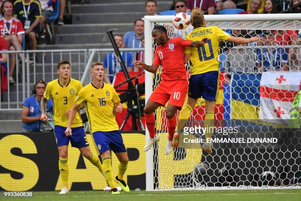 England's forward Raheem Sterling heads the ball with Sweden's midfielder Emil Forsberg during the Russia 2018 World Cup quarter-final football match...