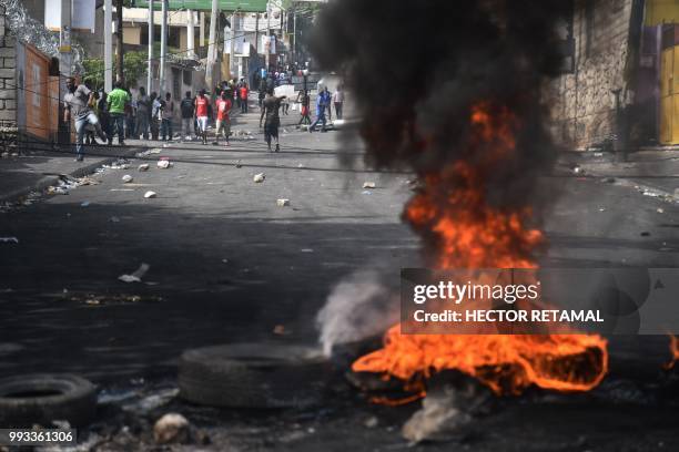 Tires burn at a barricade placed by demonstrators on the streets of the Port-au-Prince suburb of Petion-Ville on July 7 to protest against the...