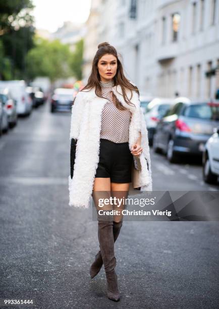 Guest wearing white fake faux jacket, overknees , black shots turtleneck top seen outside Valentino on day four during Paris Fashion Week Haute...
