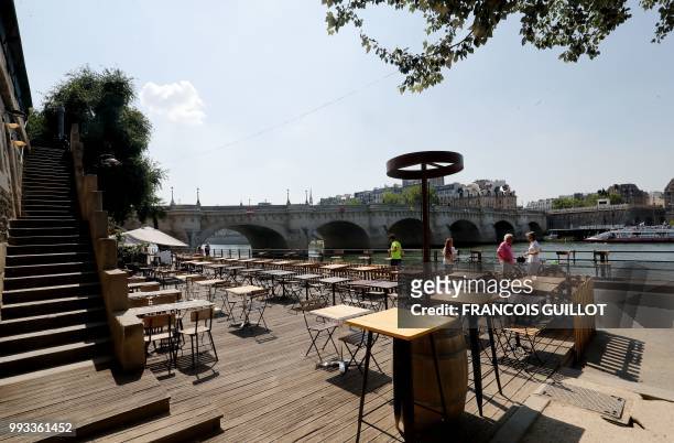 Picture taken on July 7, 2018 during the 17th edition of Paris Plage summer event shows a terrasse on the banks of the river Seine in Paris.