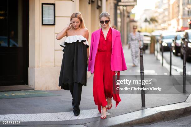 Tina Leung and Caroline Daur wearing red dress, sunglasses seen outside Valentino on day four during Paris Fashion Week Haute Couture FW18 on July 4,...