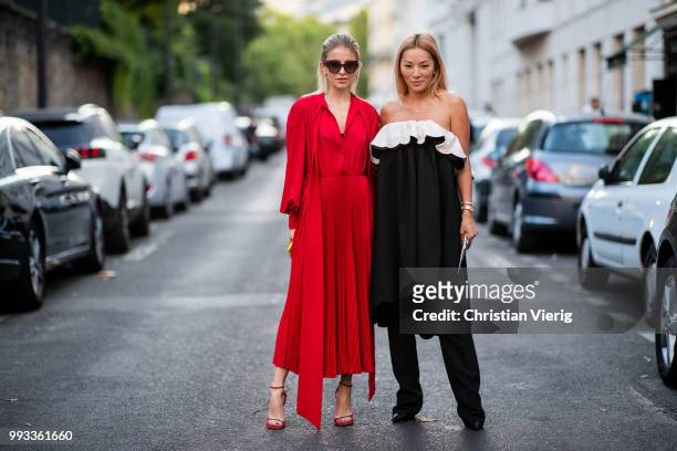 Tina Leung and Caroline Daur wearing red dress, sunglasses seen outside Valentino on day four during Paris Fashion Week Haute Couture FW18 on July 4,...