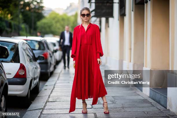 Caroline Daur wearing red dress, sunglasses seen outside Valentino on day four during Paris Fashion Week Haute Couture FW18 on July 4, 2018 in Paris,...