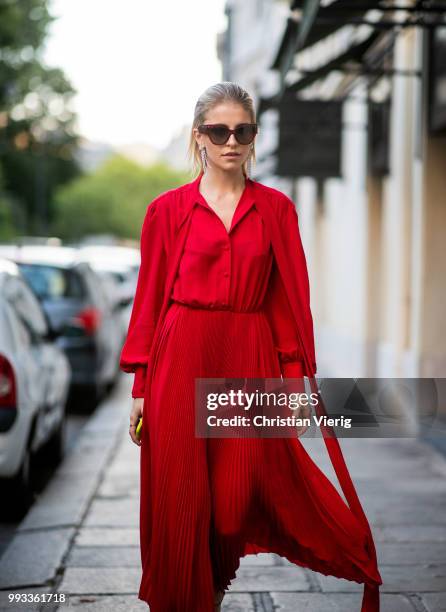 Caroline Daur wearing red dress, sunglasses seen outside Valentino on day four during Paris Fashion Week Haute Couture FW18 on July 4, 2018 in Paris,...