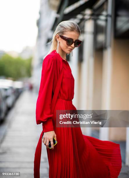 Caroline Daur wearing red dress, sunglasses seen outside Valentino on day four during Paris Fashion Week Haute Couture FW18 on July 4, 2018 in Paris,...