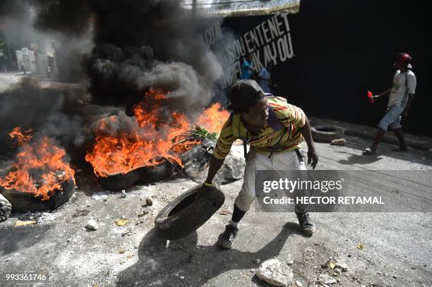 Protesters barricade a street in the Port-au-Prince suburb of Petion-Ville on July 7 to protest against the increase in fuel prices. - Haiti's Prime...