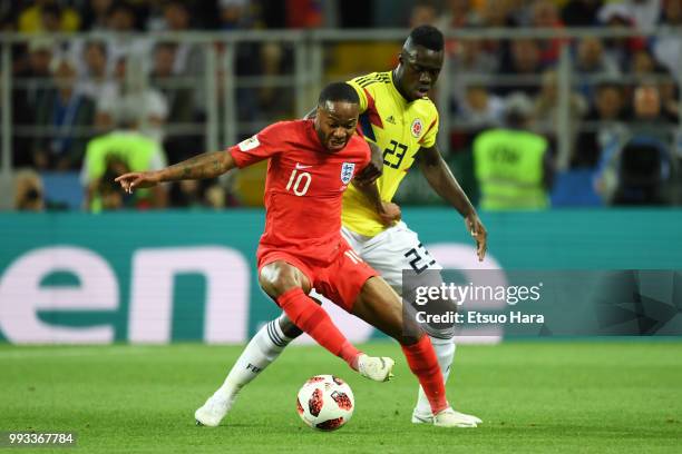 Raheem Sterling of England and Davinson Sanchez of Colombia compete for the ball during the 2018 FIFA World Cup Russia Round of 16 match between...